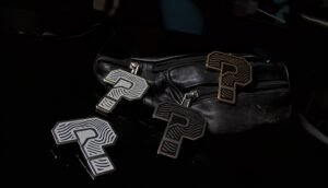 Custom ZipDrip Zipper Pulls on a black leather bag