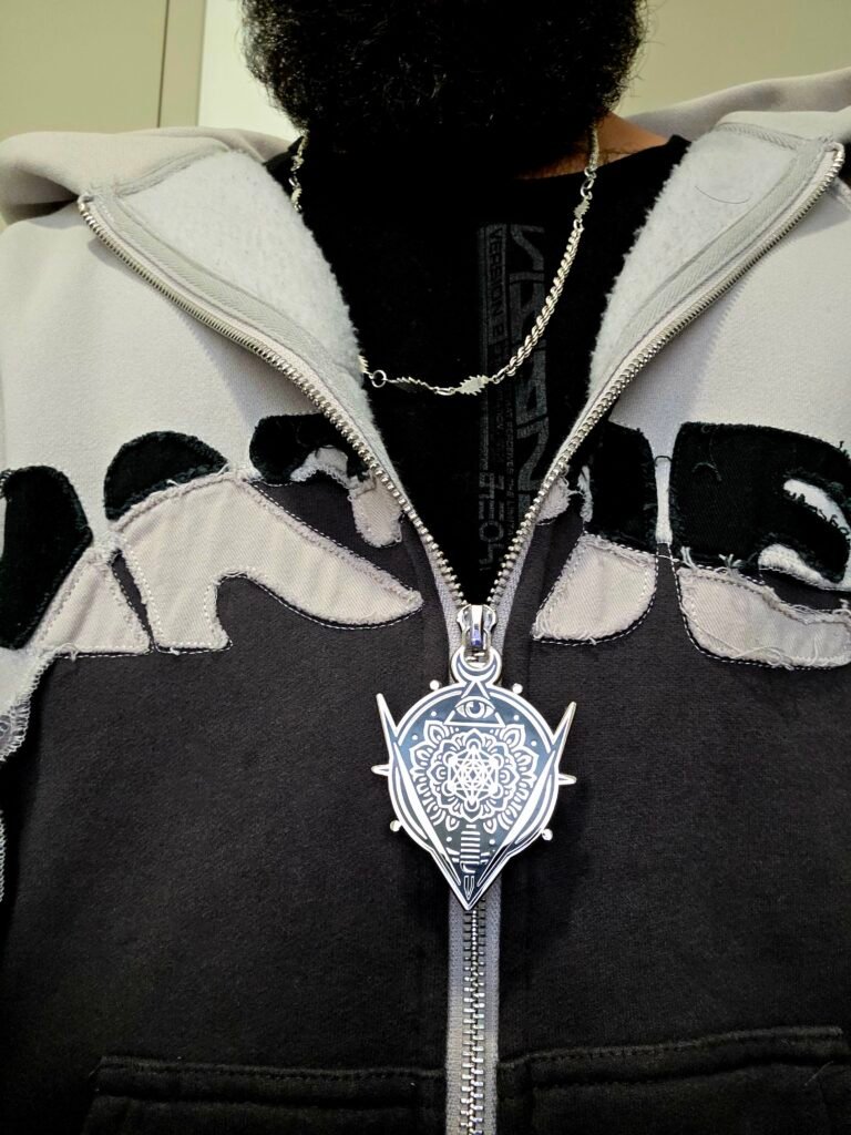 ZipDrip crest zipper pull on a black and white hoodie